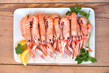 Wall Mural - boiled crayfish, with oil and lemon sauce, on a plate, karavides in Greek