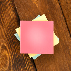 Blank colorful stickers on wooden brown table