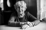 Fototapeta  - An old pensioner woman in her house. Black and white photo.