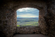 Landscape view through the window of a medieval castle.