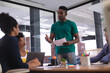 © Wavebreak Media - African american man giving speech to diverse group of colleagues in meeting room