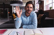 © Wavebreak Media - Caucasian businessman sitting at desk with documents saying hello having video call