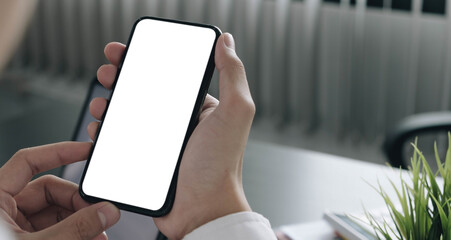 Mockup image of hand holding mobile phone with blank white screen in home