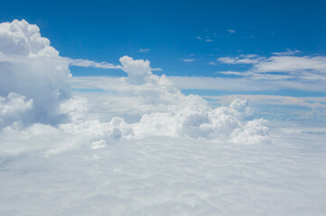 Wall Mural - over the clouds,Blue sky with tiny clouds background Beautiful natural view from airplane window above. Background or Wallpaper.blue sky and cloud sky nature.Top view of aircraft