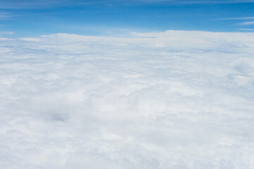 Wall Mural - over the clouds,Blue sky with tiny clouds background Beautiful natural view from airplane window above. Background or Wallpaper.blue sky and cloud sky nature.Top view of aircraft