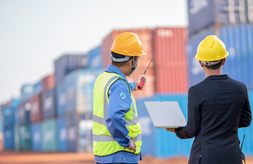 Teem of engineering or foreman control and market manager or business man wearing helmet working togeter in container stockside Transport and logistic international import export partnership concept