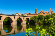 Montauban City On Sunny Day. Medieval Bridge Over The Tarn River. France
