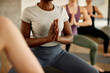 © Drazen - Close-up of black female athlete practicing Yoga during sports training at health club.