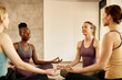 © Drazen - Multi-ethnic group of athletic women practicing Yoga in lotus pose at health club.