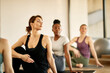 © Drazen - Group of athletic women doing stretching exercises at health club.