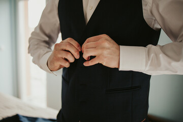 Sticker - Groom clasping the button of his waistcoat and getting prepared for his wedding