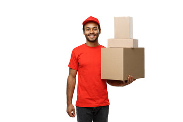 Wall Mural - Delivery Concept - Portrait of Happy African American delivery man in red cloth holding a box package. Isolated on white studio Background. Copy Space