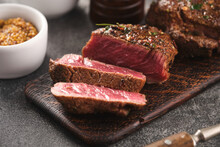 Grilled Beef Fillet Steaks With Herbs And Spices On Wooden Board. Two Fillet Mignon. Fillet Of Beef.