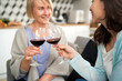 © gpointstudio - Two generation women toasting in wine at home