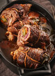 Dish of beef, bacon and pickle roulades in gravy seasoned with vegetables for a traditional regional German dinner. German traditional cuisine beef roulade with bacon and vegetables
