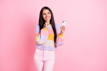 Poster - Photo of young cheerful girl happy positive smile think dream look empty space use cellphone isolated over pastel color background