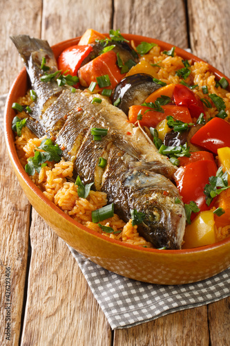 Obraz Dibond Thieboudienne Fish and Rice The National food of Senegal closeup in the dish on the table. Vertical