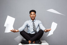Business Concept - Handsome Young Professional African American Businessman Throwing Away Pile Of Paperworks Flying On Air.