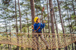 © galitskaya - Happy child in a helmet, healthy teenager school boy enjoying activity in a climbing adventure park on a summer day