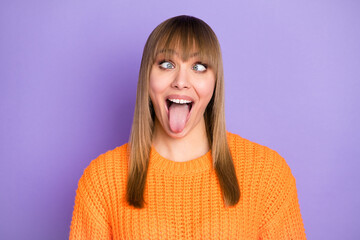 Wall Mural - Photo portrait of silly childish blonde girl grimacing showing tongue isolated pastel purple color background