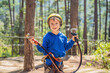 © galitskaya - Happy child in a helmet, healthy teenager school boy enjoying activity in a climbing adventure park on a summer day