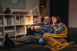 © cherryandbees - middle age romantic couple enjoying time together at home. they are watching television