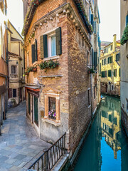 Wall Mural - Venice, Italy, February, 13, 2021 - house corner between street and canal in Venice