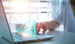 © teerawat - Businessman stock trading at home by using smart phone and laptop. The planning concept to increase business growth and the rise of indicators of positive growth and marketing strategies.