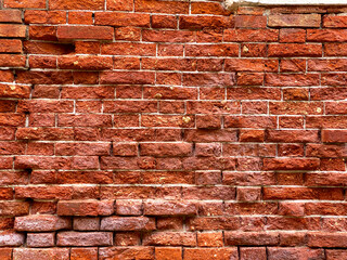 Horizontal part of a Venetian old red brick wall, background,