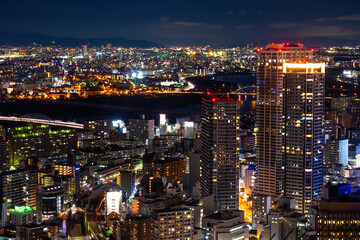 Wall Mural - Japan. Night panorama of Osaka. Evening Osaka aerial view. Lights of the night city in Japan. Construction of overpass in Japan. River in the middle of the city. Traveling in Japan. Tour to Osaka.