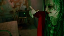 Creepy Clown Woman Dancing In A Nightmarish Room. Scary Clown Grimaces And Moves Nervously