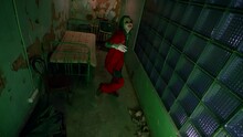 A Clown Woman In A Red Suit Dances In A Nightmarish Room With A Bed. Scary Clown Grimaces And Moves Nervously