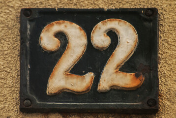 Wall Mural - Old retro weathered cast iron plate with number 22 closeup