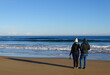 © Ayla Harbich - Couple standing in the sand, at beach, Ireland travel destination.