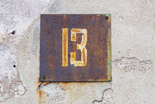 A Sign With The Number Thirteen On The Wall Of The House. Unfortunate Number