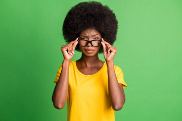 Sticker - Photo of young unhappy upset mad afro girl in glasses staring angrily having conflict isolated on green color background