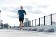 © opolja - Fitness, workout, sport, lifestyle concept. Middle-aged man running in the city