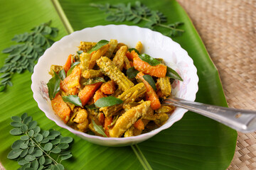 Wall Mural - Aviyal curry for Onam Sadhya mixed vegetable curry with grated coconut side dish of rice Kerala on banana leaf background Kerala, Tamil Nadu in South India. Top view Indian veg festival food.