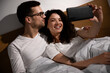 © Zoran Zeremski - Smiling couple in the morning laying in bed in the bedroom making selfie.
