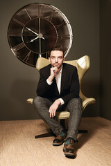 Poster - fashionable man poses in armchair