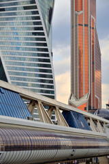 Wall Mural - View of Bagration Bridge against background of high-rise buildings in Moscow City on clear sunny day, Moscow, Russia