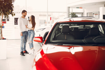 Stylish and elegant family in a car salon