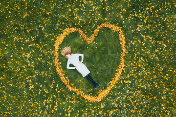 Heart made from autumn leaves. Curly girl.