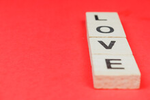 Love Wooden Block Word With Red Background. Heart And Love Concept