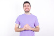© Jihan - Business Concept - Portrait of young handsome caucasian man wearing purple t-shirt against white background holding hands with confident face.