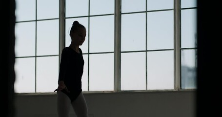 Teen girl wearing black leotard dancing. Silhouette of young dedicated dancer having a practice session - childhood dream, arts 4k footage