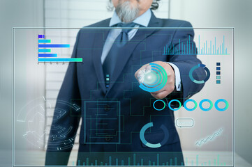 A businessman works on a Touchscreen Interface with Technology in business data. Futuristic style, on blue background.