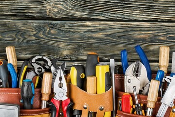 Wall Mural - Tool belt with tools on wooden desk