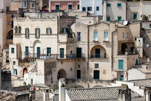 Old Stones House Buildings And Ancient Italian Village In Matera In Italy. Full Picture Of White Buildings Made With Stones. Cluster Of Houses. Matera, Italy.