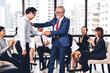 © Art_Photo - Image two business partners successful handshake together in front of teamwork casual business winning success agreement in modern office.Partnership approval and teamwork